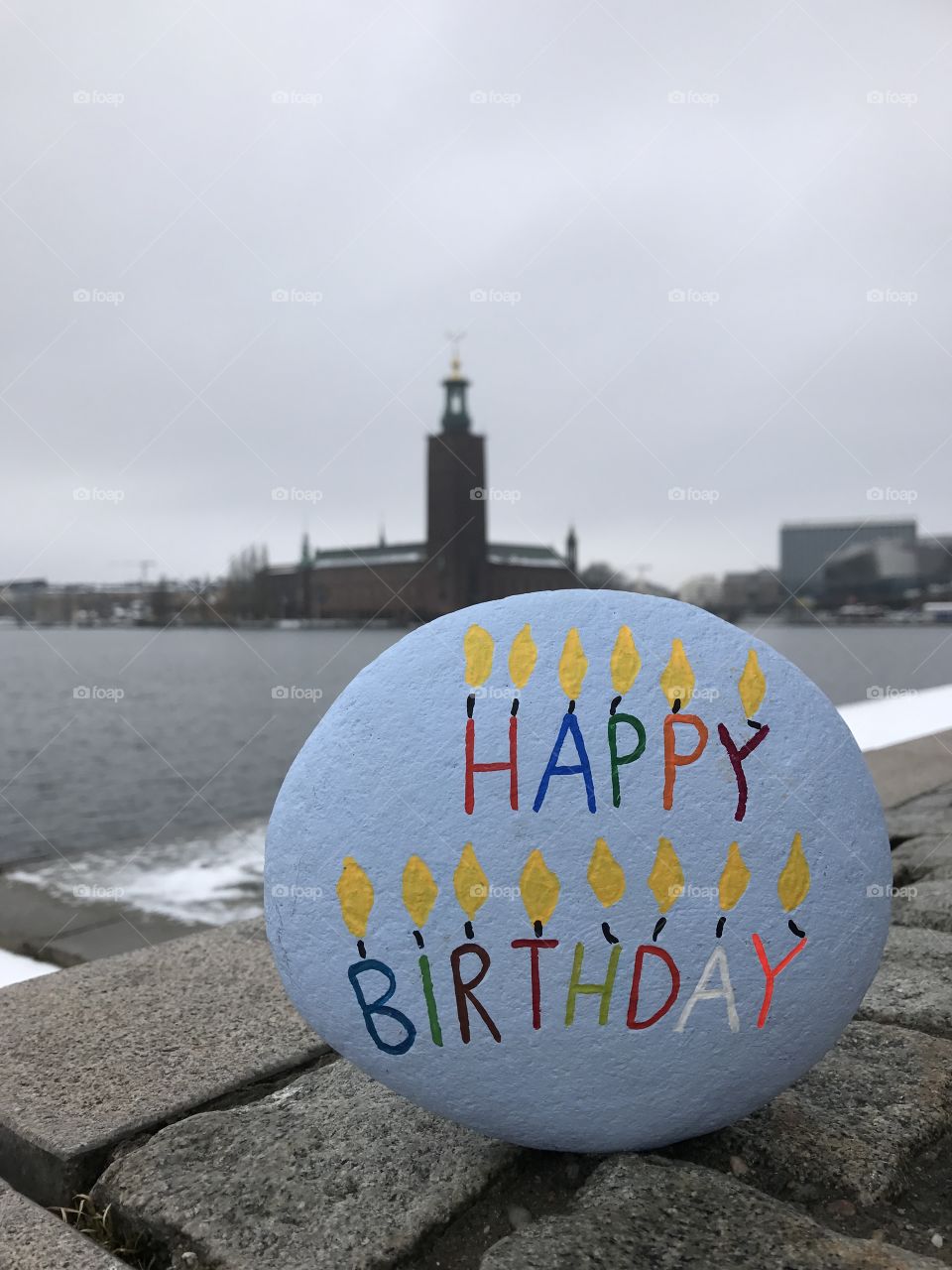 Happy Birthday stone with City Hall of Stockholm background