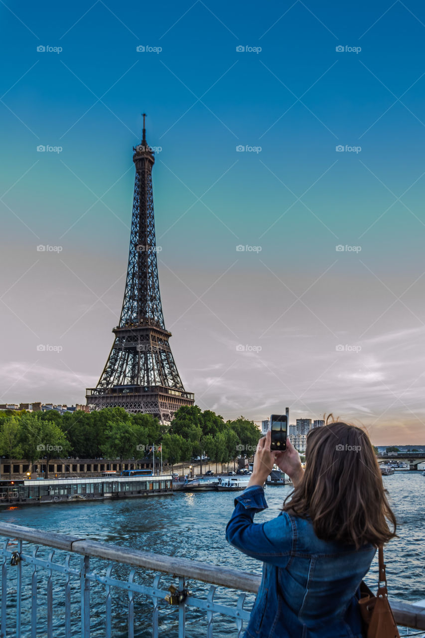 Picture of Paris by a tourist. Tourist taking a picture of the Eiffel Tower
