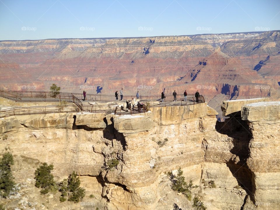 Tourists enjoying view of grand canyon