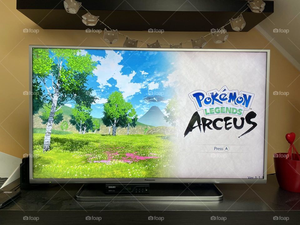 Pokemon Legends Arceus a video game published by the Pokemon Company and Nintendo for the Nintendo Switch on the TV in the living room.