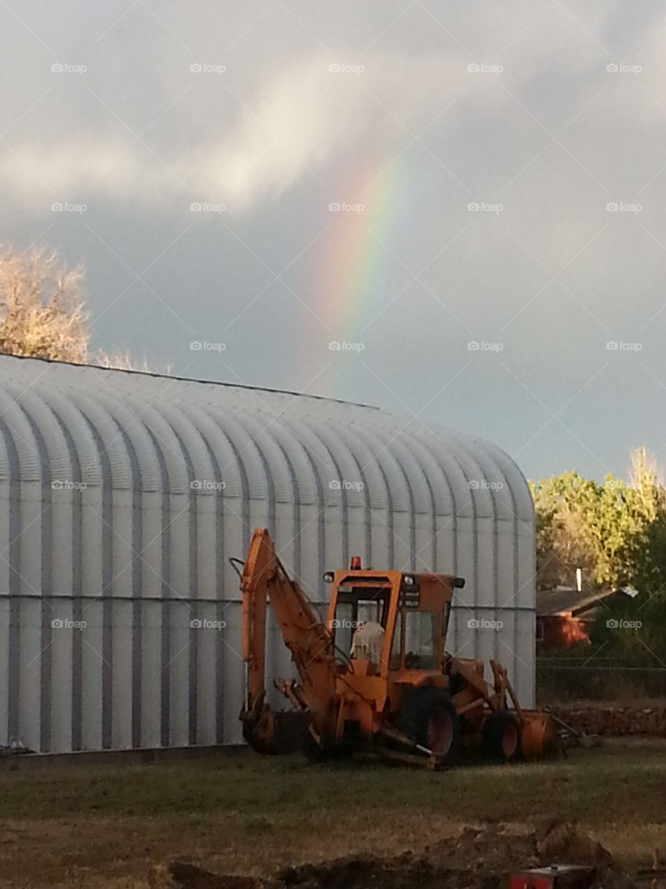 Rainbow over metal building. Rainbow over metal building