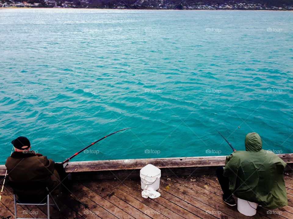 Buddies. Men fishing at Lorne Pier, Victoria, Australia