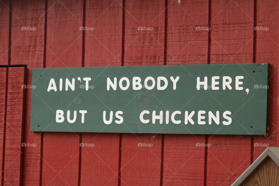 Saying on wood against a red barn