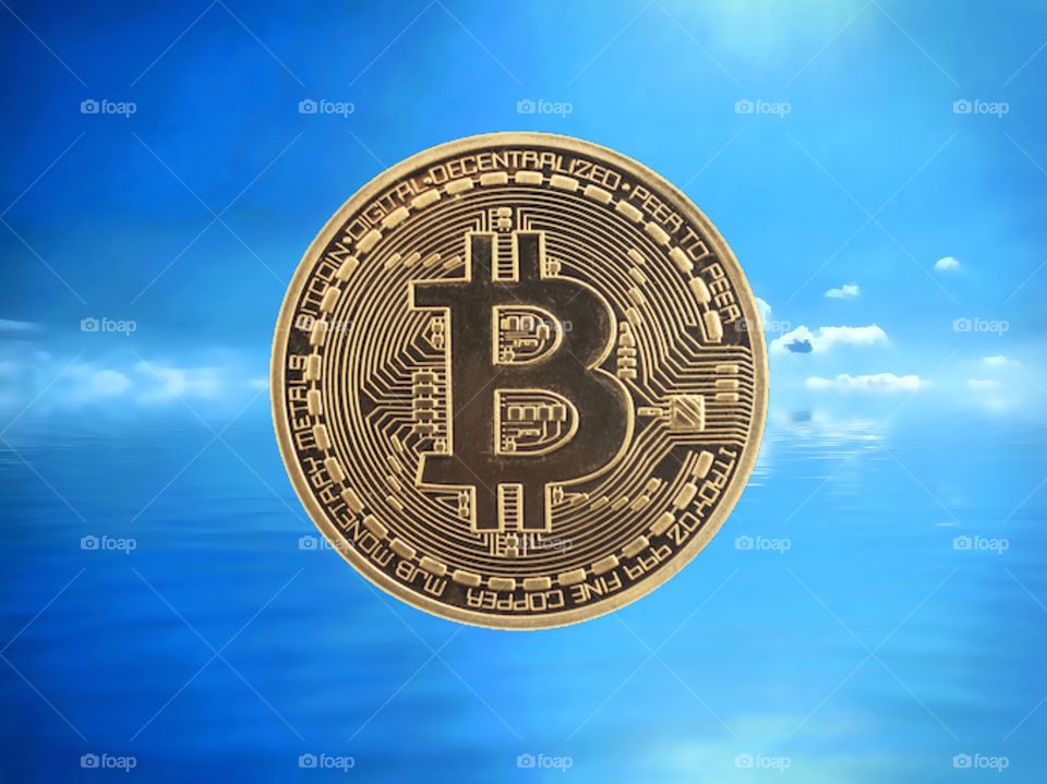 Bitcoin against a blue sky