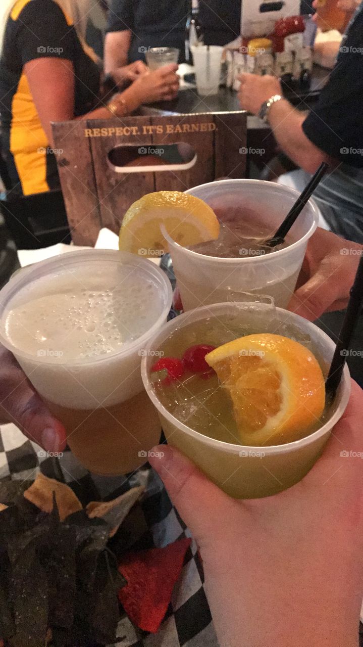 Cheers by chicks clinking plastic cups 