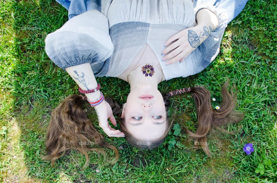 Portrait of Young Girl on Background of Daisies