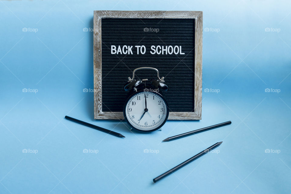 Back to school concept. Alarm set to 7am. Pencils sharpened.