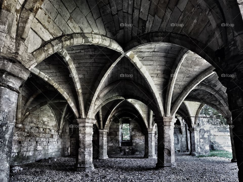 The interior of a gothic church with stone pillars and arched ceilings