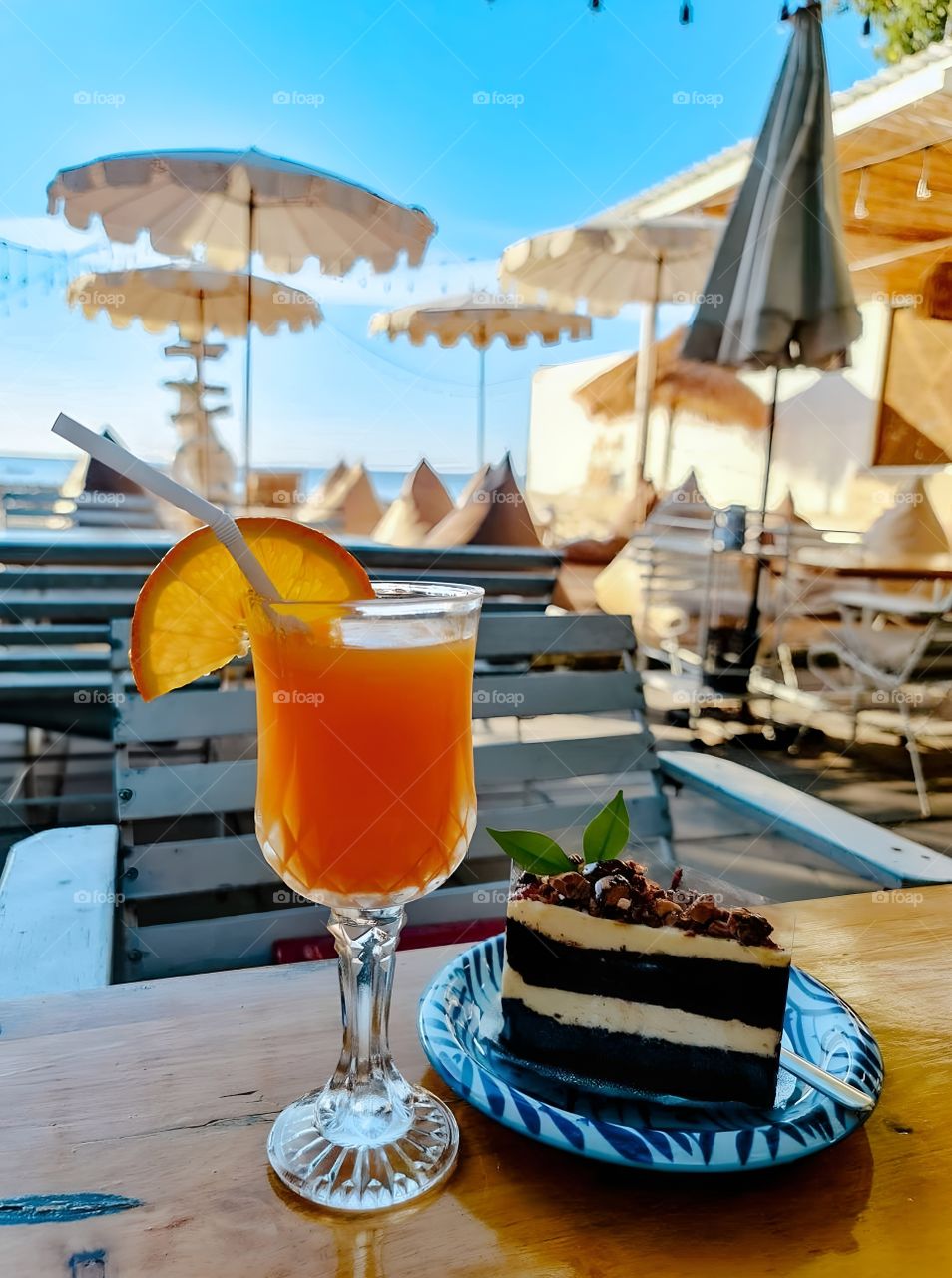 orange juice and cake on the beach