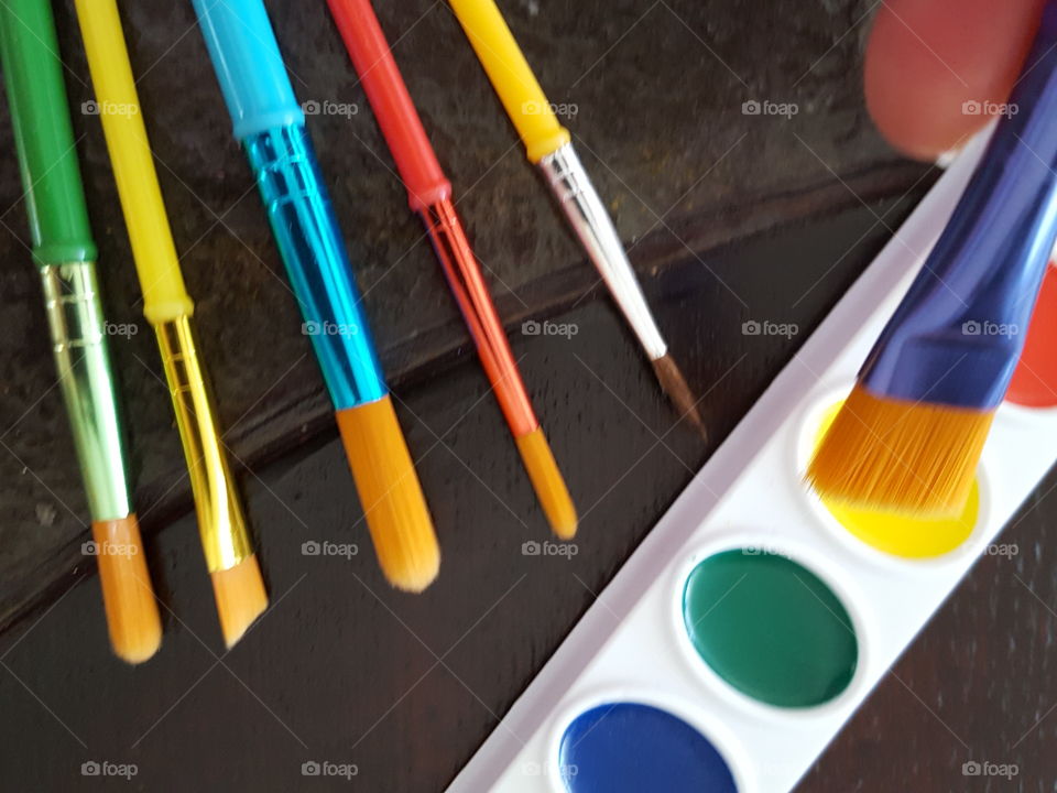 Close-up of color box with brushes on table