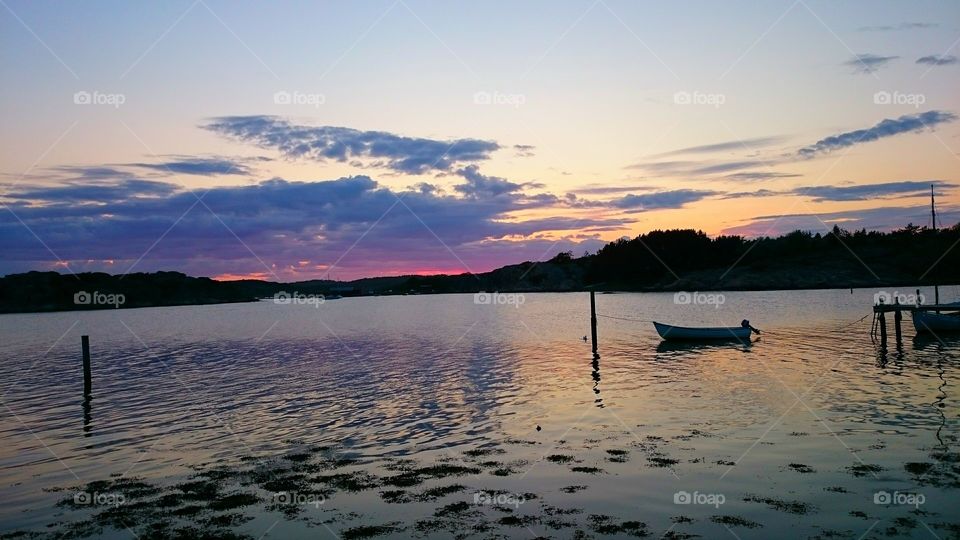 Silhouette of boat in sea at sunset