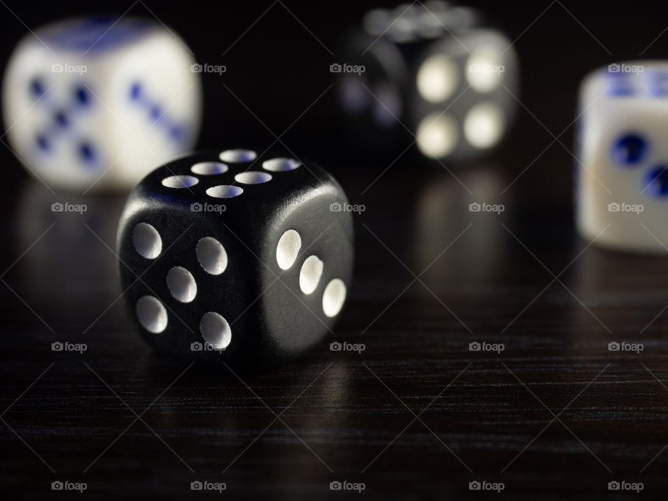 Table gambling with dice in the evening with dim light on a dark background
