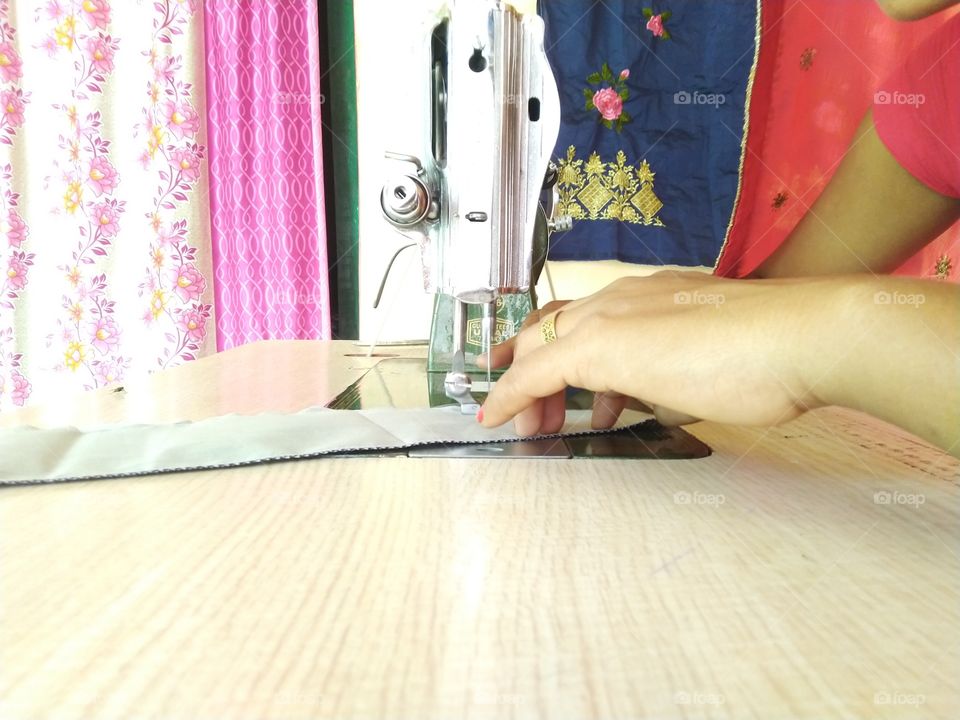 lady tailor sewing the clothes at home business