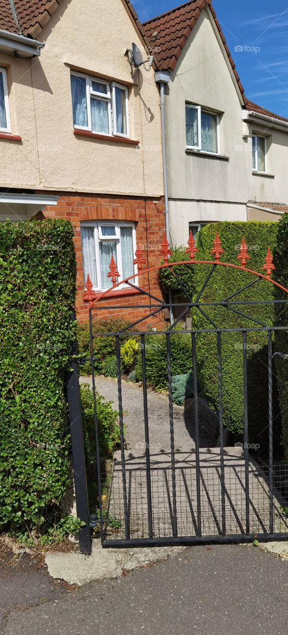 Entrada o pórtico a una casa con jardín cuidado