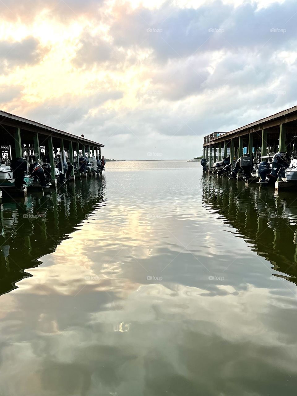 Calm waters for boats that are docked in Texas. Lovely reflection of clouds and sky. 