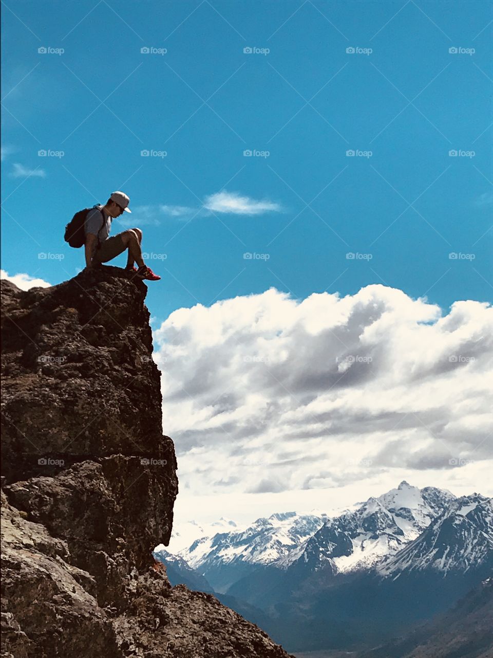 Sitting on edge of cliff at Tucker Mountain, Eagle River, Alaska.