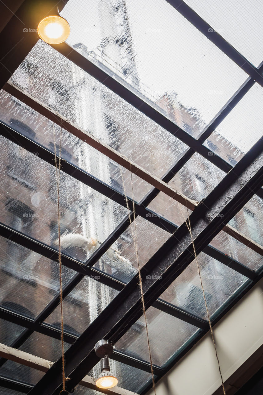 Abstract rainy day under a glass roof in New York 