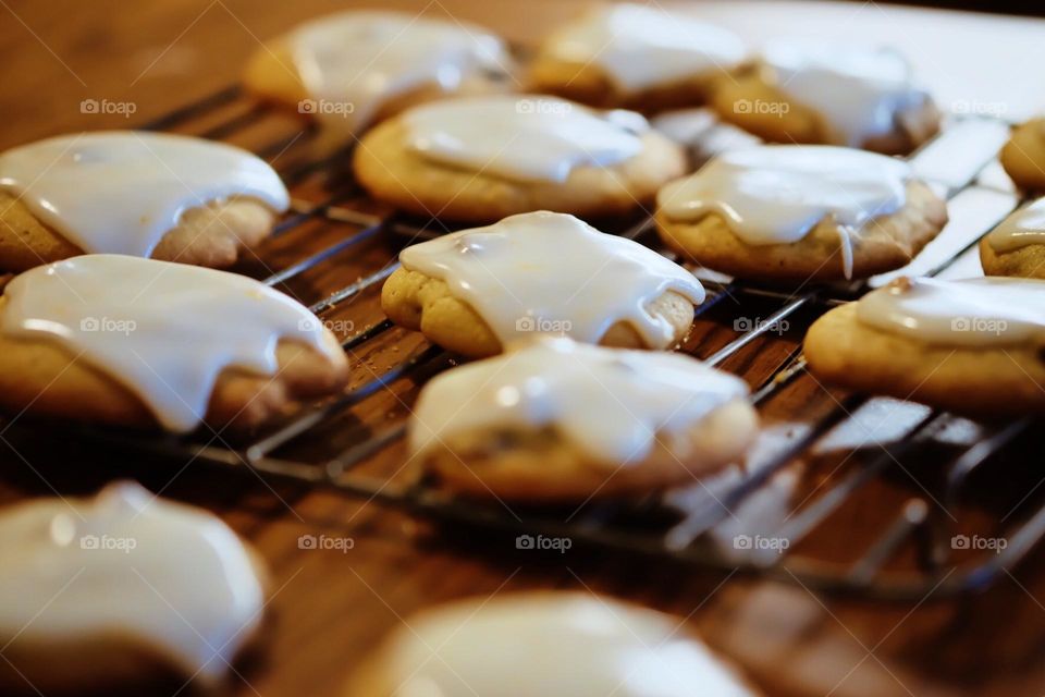 Icing on cookies, cookies cooling on the rack, icing the homemade cookies, delicious treats in the kitchen, baking with Momn