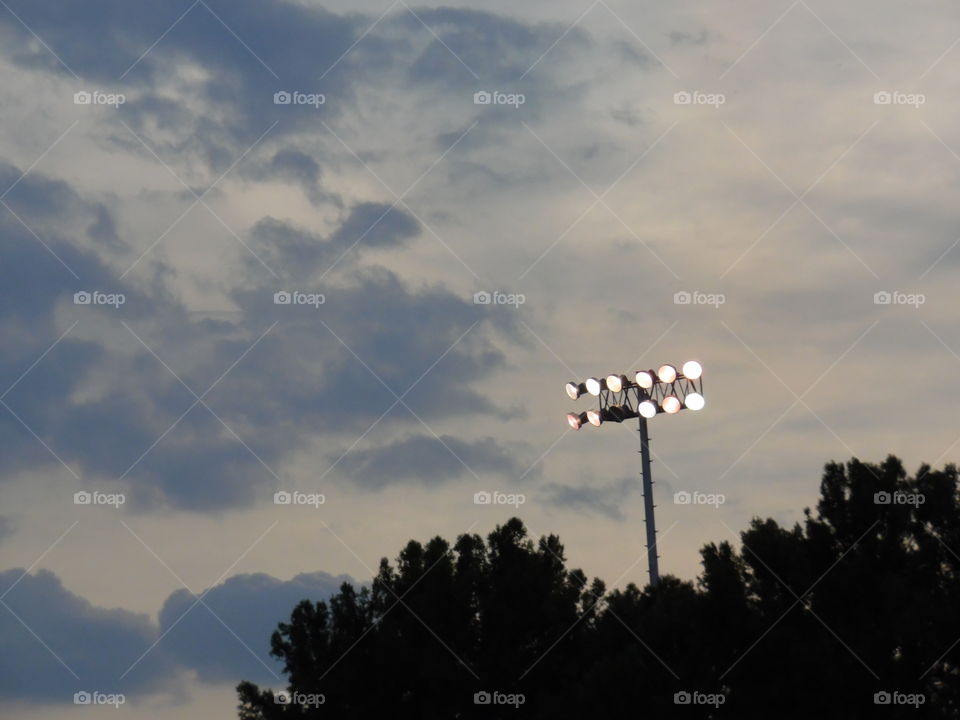 stadium lights. This is a picture of the lights at the football field. 👣 🚶 🏃 🔥 💨