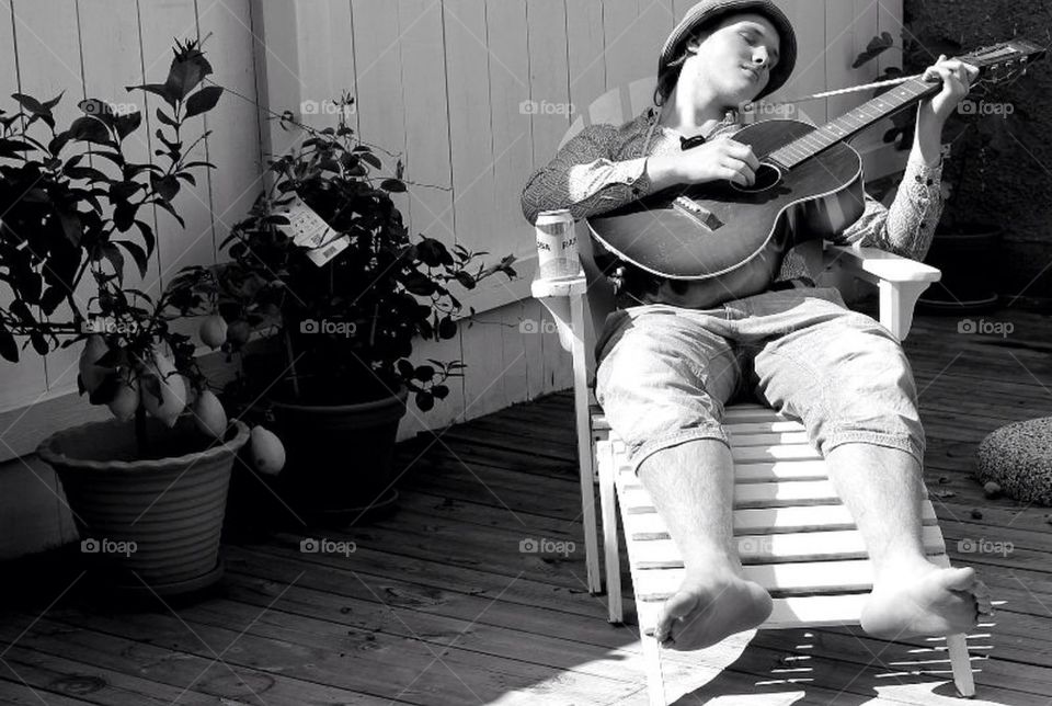 My son and his old guitar  (alone ) in the garden...