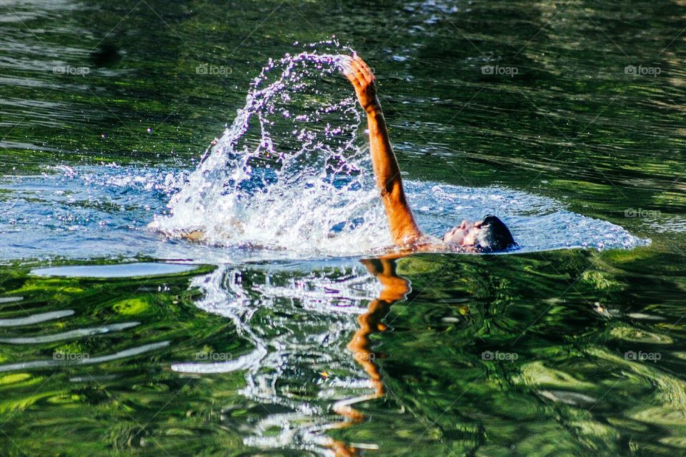 boy swimming in lake. summer time.