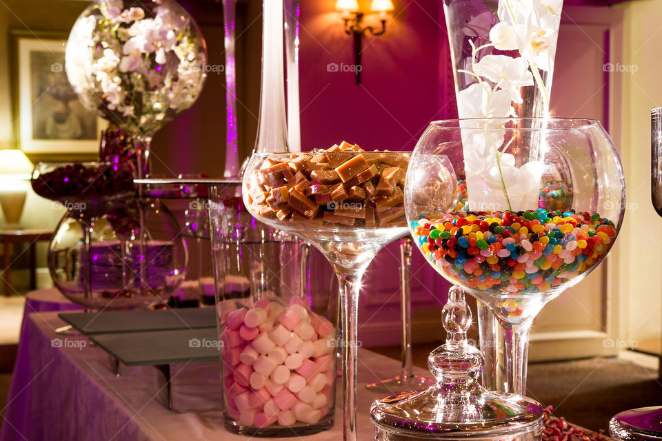 Glass jars and holders filled with different sweets treats and sugar eats