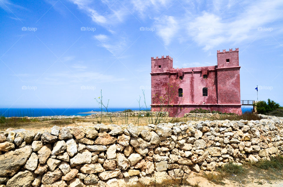 Saint Agath's Red Tower in Mellieha Bay by the Mediterranean Sea, Malta