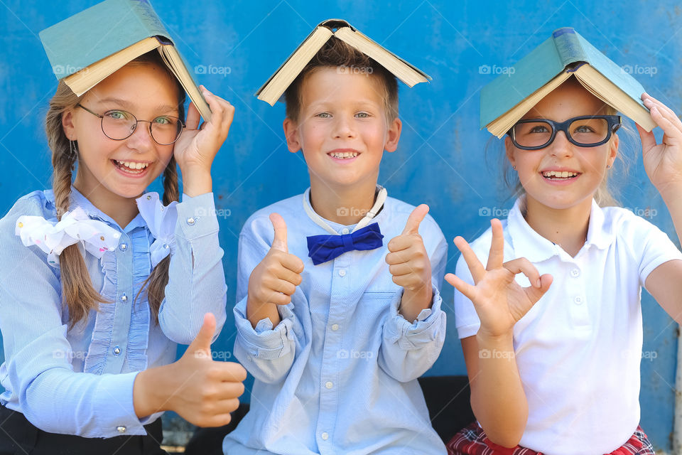 smart kids, beautiful and talented are returning to school after summer holidays!  brother and two sisters are happy to go to school, emotions, joy, happiness