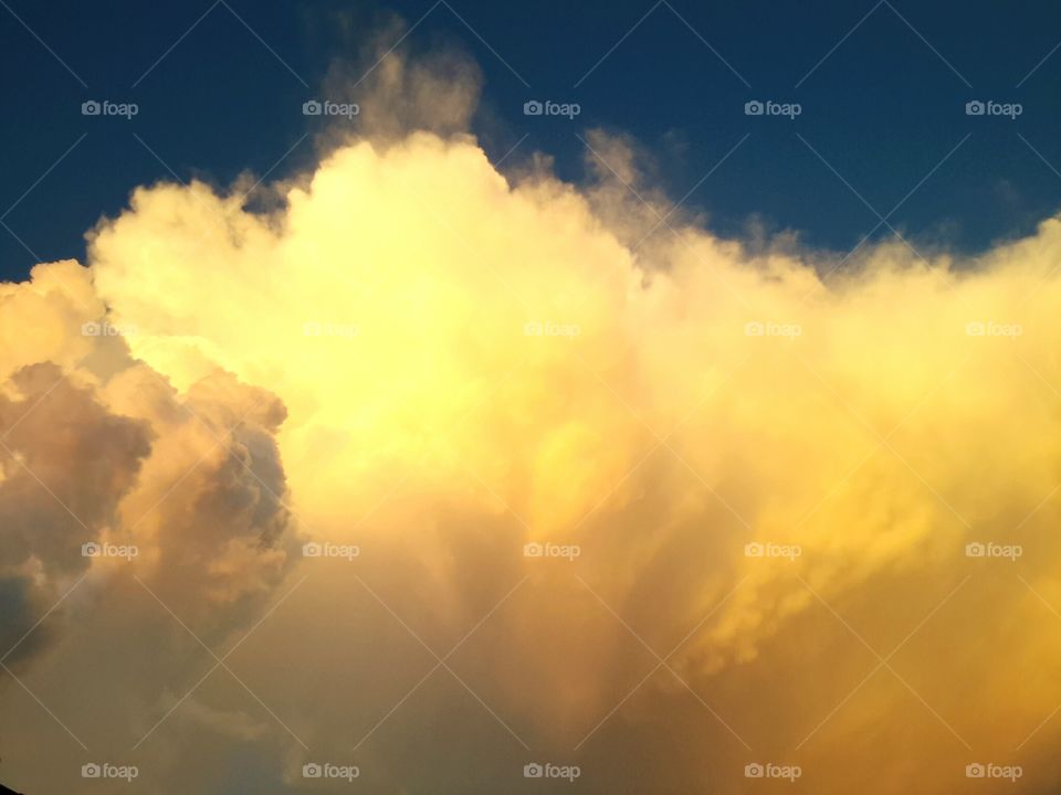 golden clouds. towering cloud catching the last of the sun's light as it sets