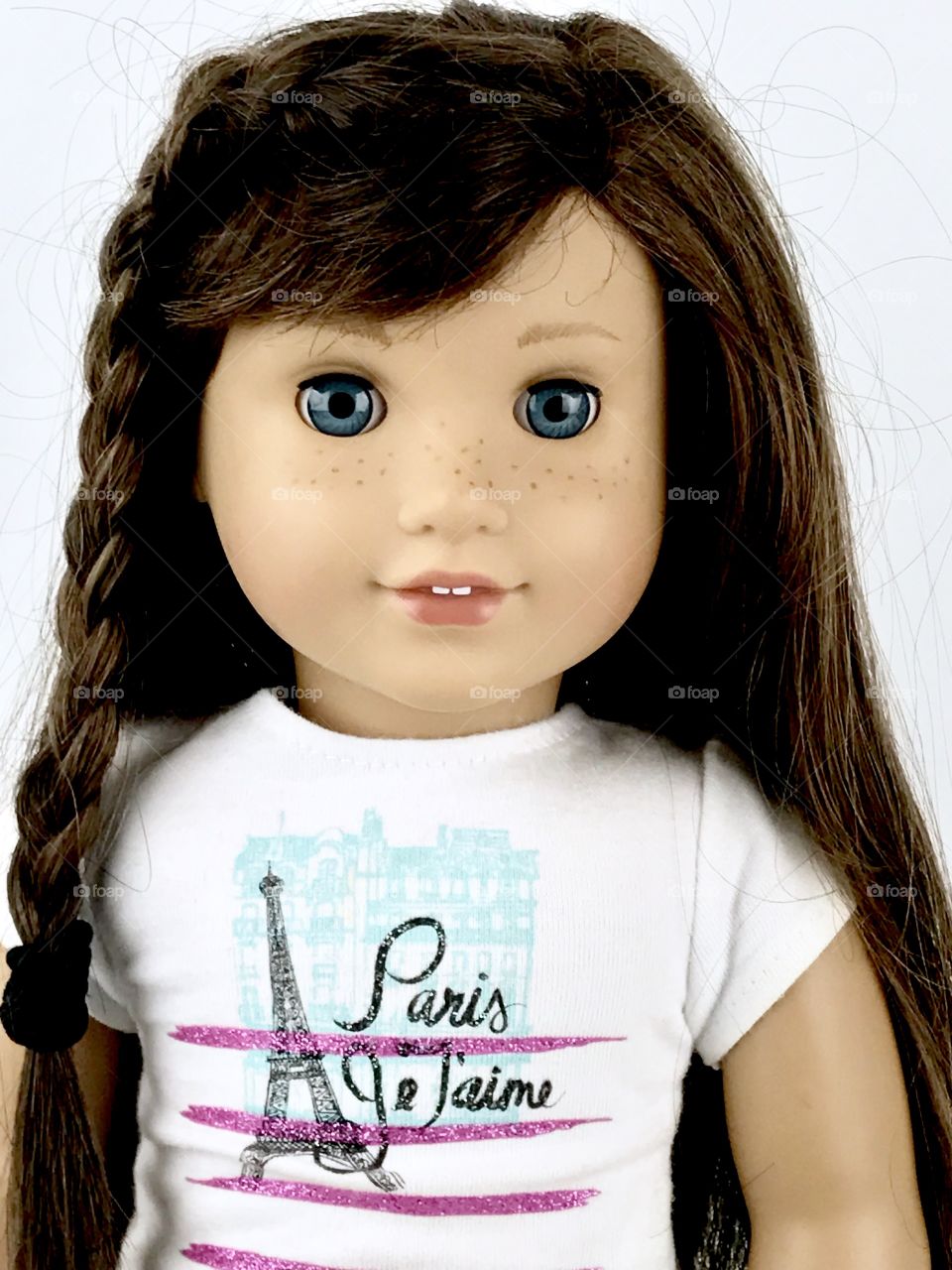 Girl doll close up. Beautiful face. Freckles. Brown hair. 