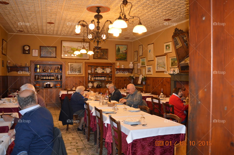 Elder woman and man sitting on restaurant