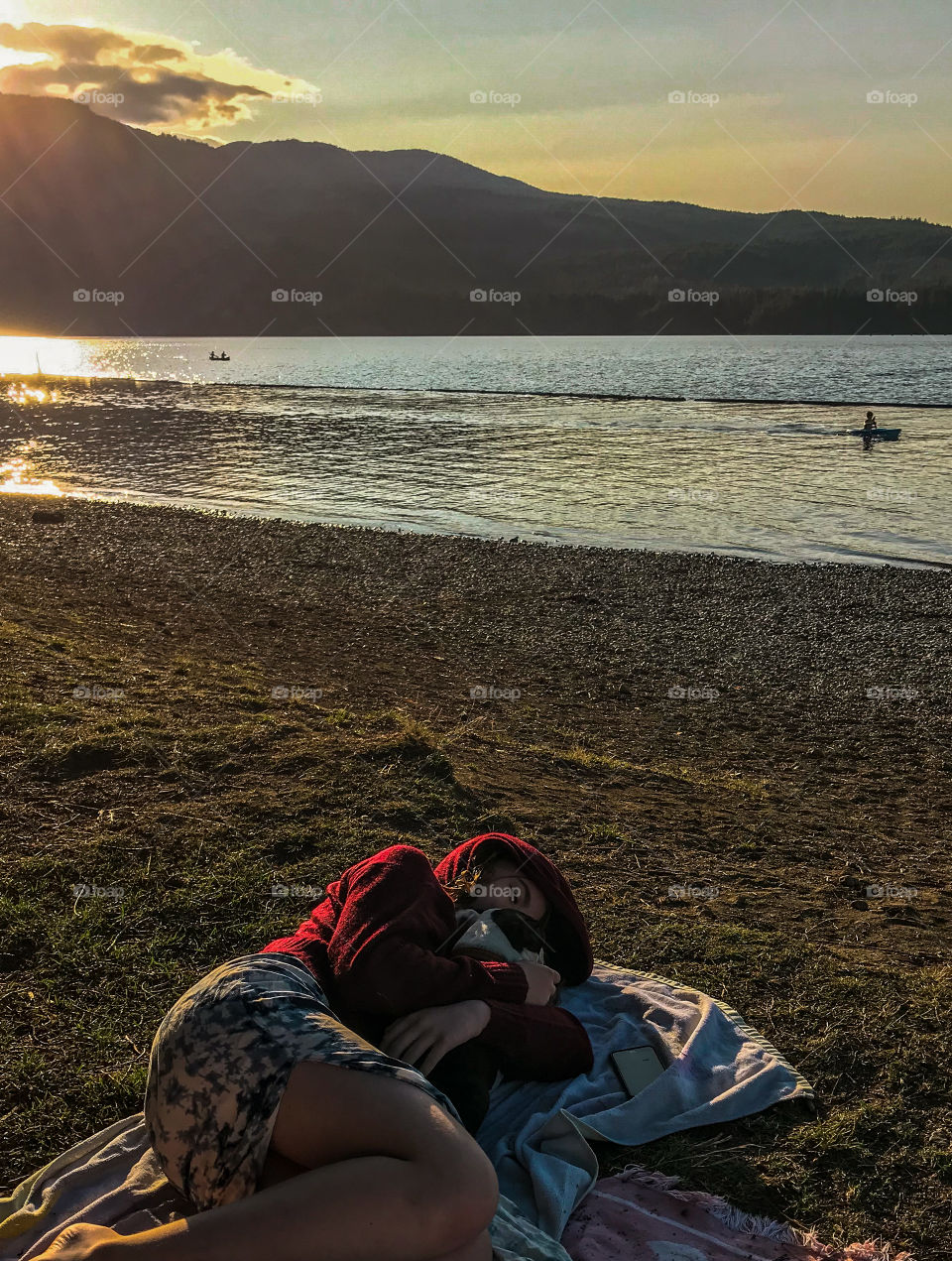 A summer afternoon at the lake stretched into evening as we enjoyed the setting sun. My daughter warmed the pup after we took her in the water to check out her life jacket. The water was cold that day but the gorgeous golden sun warmed us all. 🌄