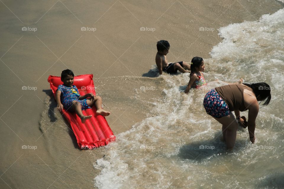 A young family having fun on the beach