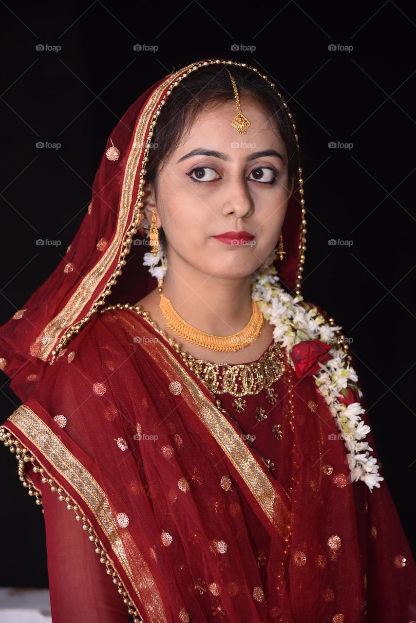 Portrait of a lady wearing heavy gold jewellery