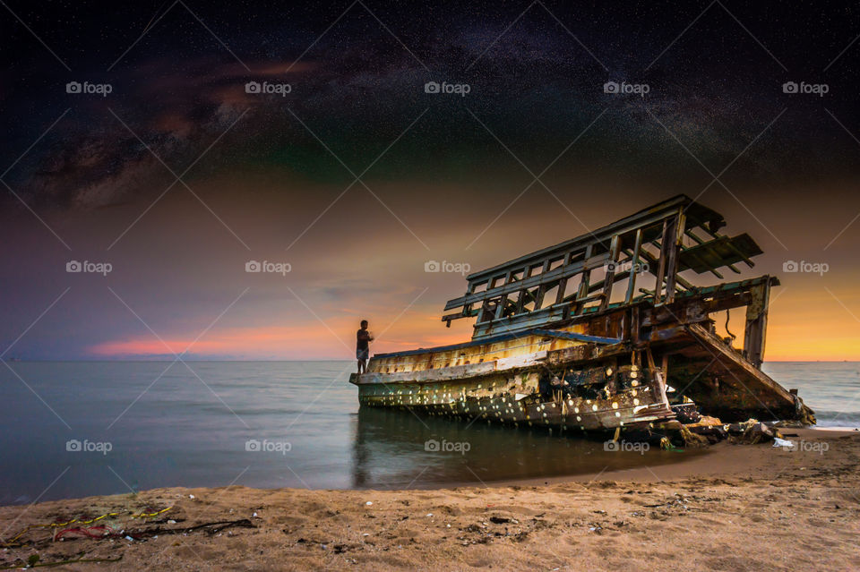 wreck on the beach and milky way