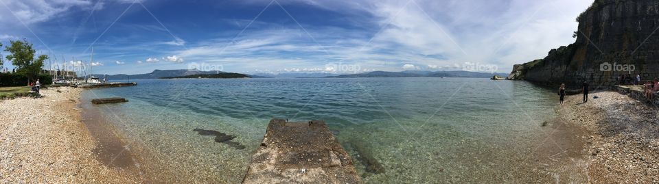 Panoramic shot of pebble beach in Corfu Town, Greece