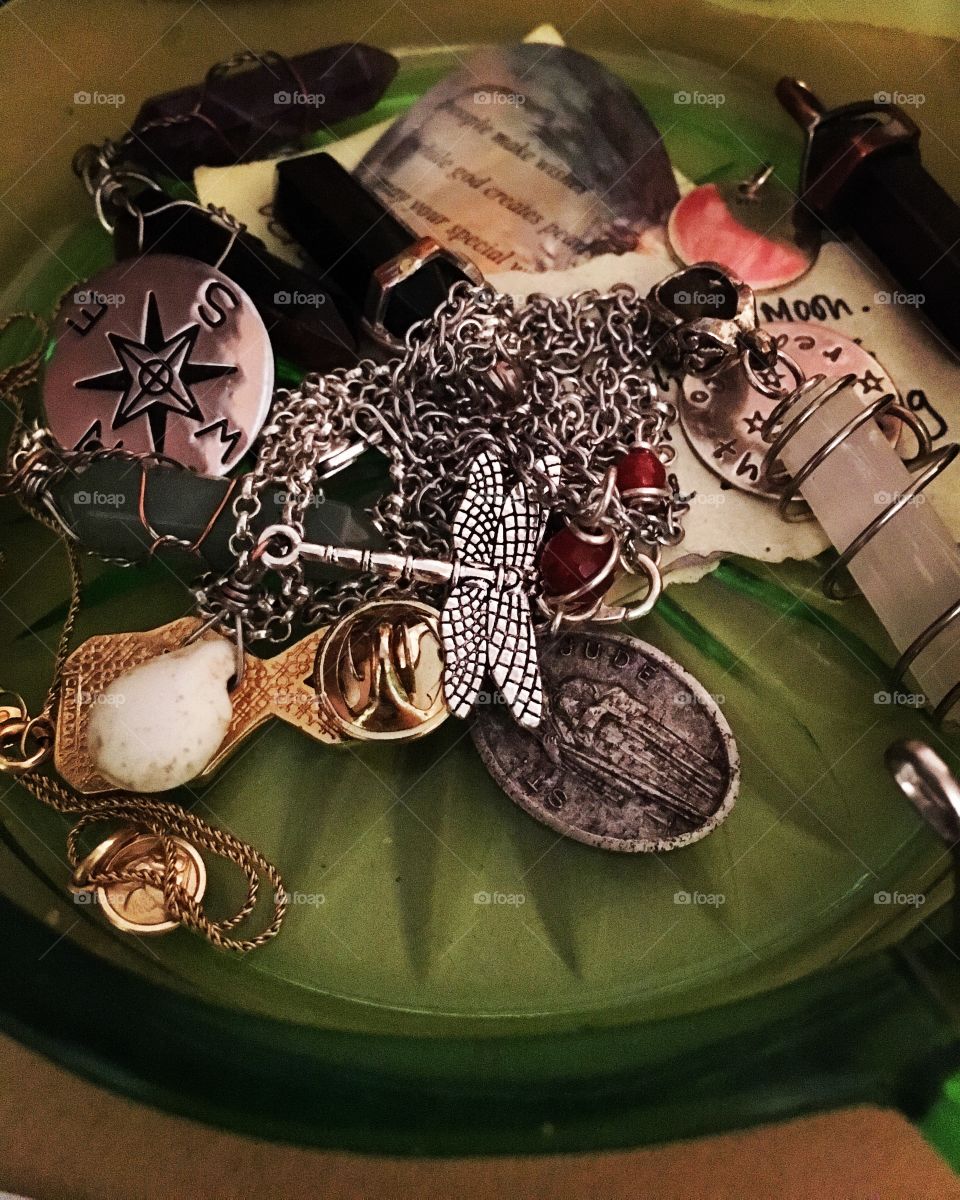 Jewelry charms in a glass dish 