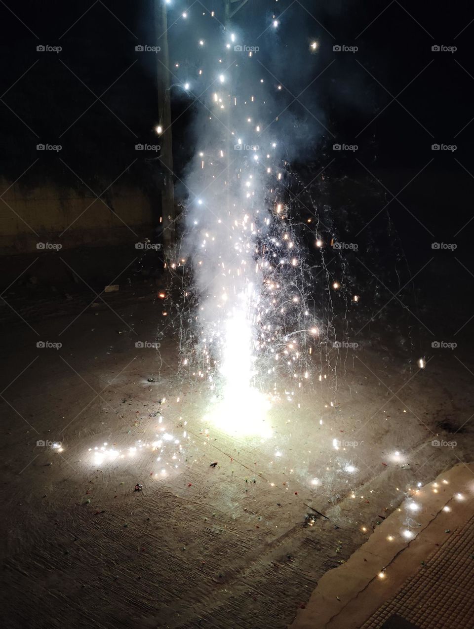 Diwali celebration with crackers and sweet, night scene, dark night,fire cracker and white light seen