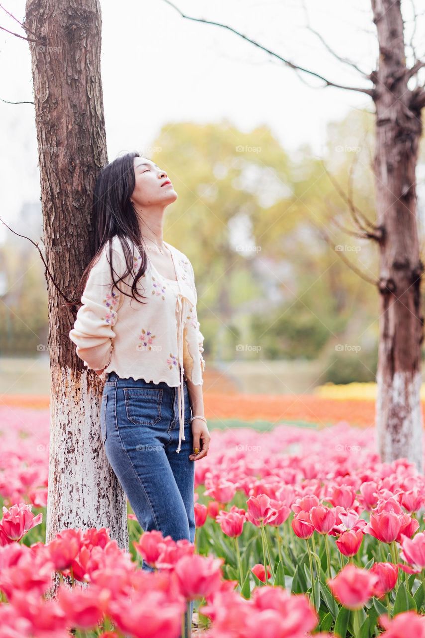 Beautiful Asian woman on tulips field 