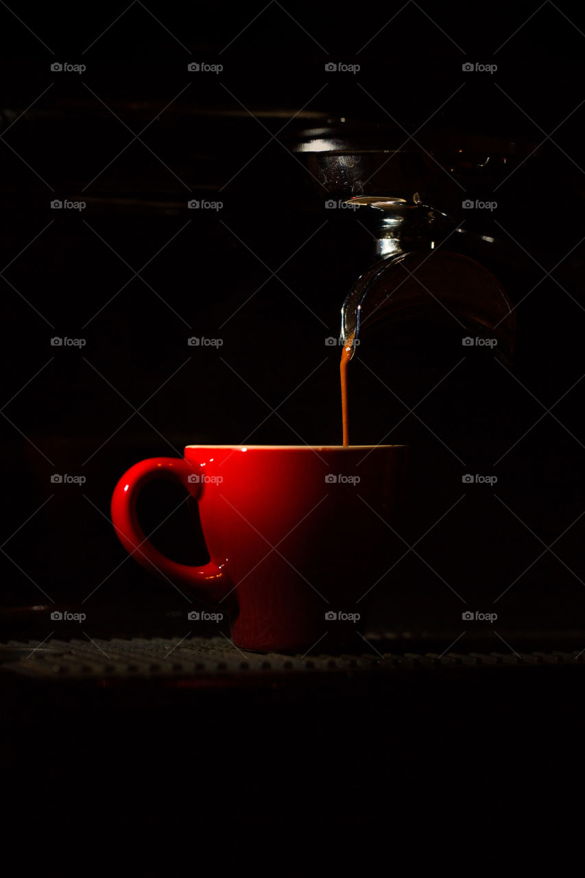 An external flash is used to create this interesting light of an espresso coffee being made. Love the color the light and of course the coffee!