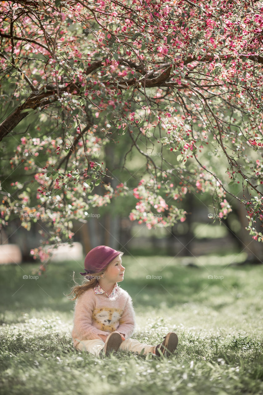 Cute Little girl in a blossom park