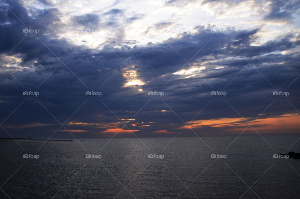 A beautiful sunrise off the horizon of the Absecon bay in Atlantic city lights up the morning sky.