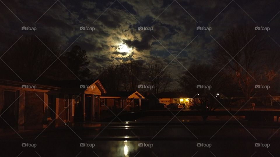 Final minutes of the 3/20/19 Super Worm Moon seen from my front yard peeking out from the clouds and reflecting off the top of my van