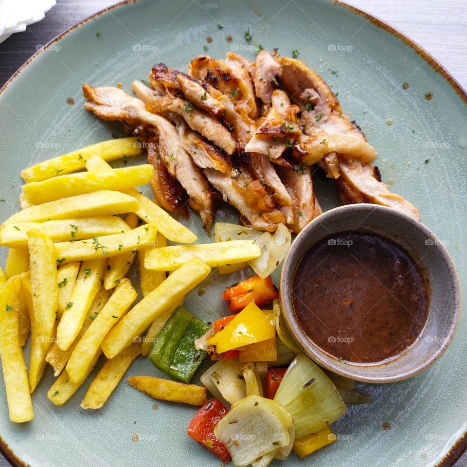 chicken slices barbecue with potatoes fried fries and sauce barbecue