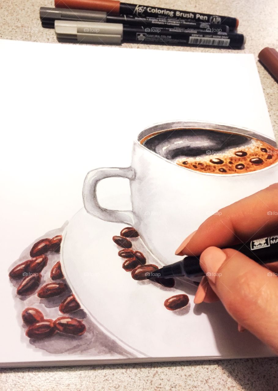 Marker drawing a cup of coffee and coffee beans