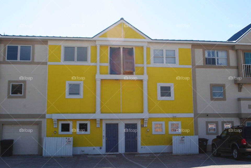 A yellow house at the beach