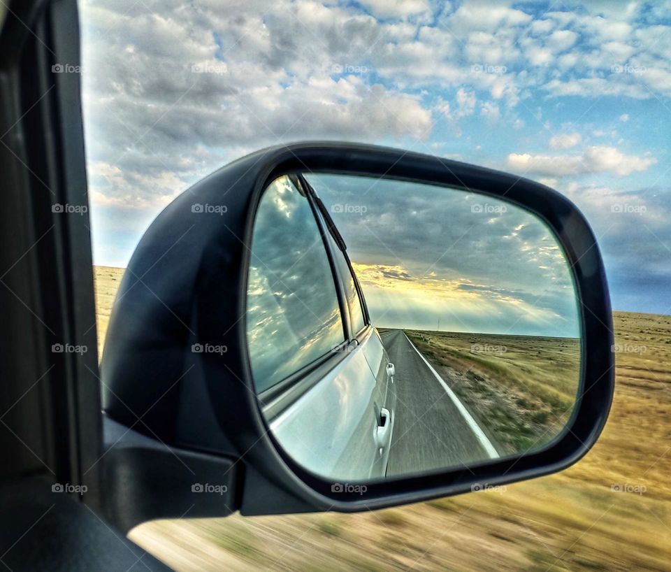 Reflection of the road in the car mirror