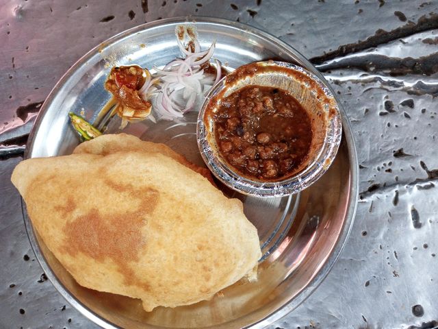 Indian street food Chole Bhature served with onion and pickle