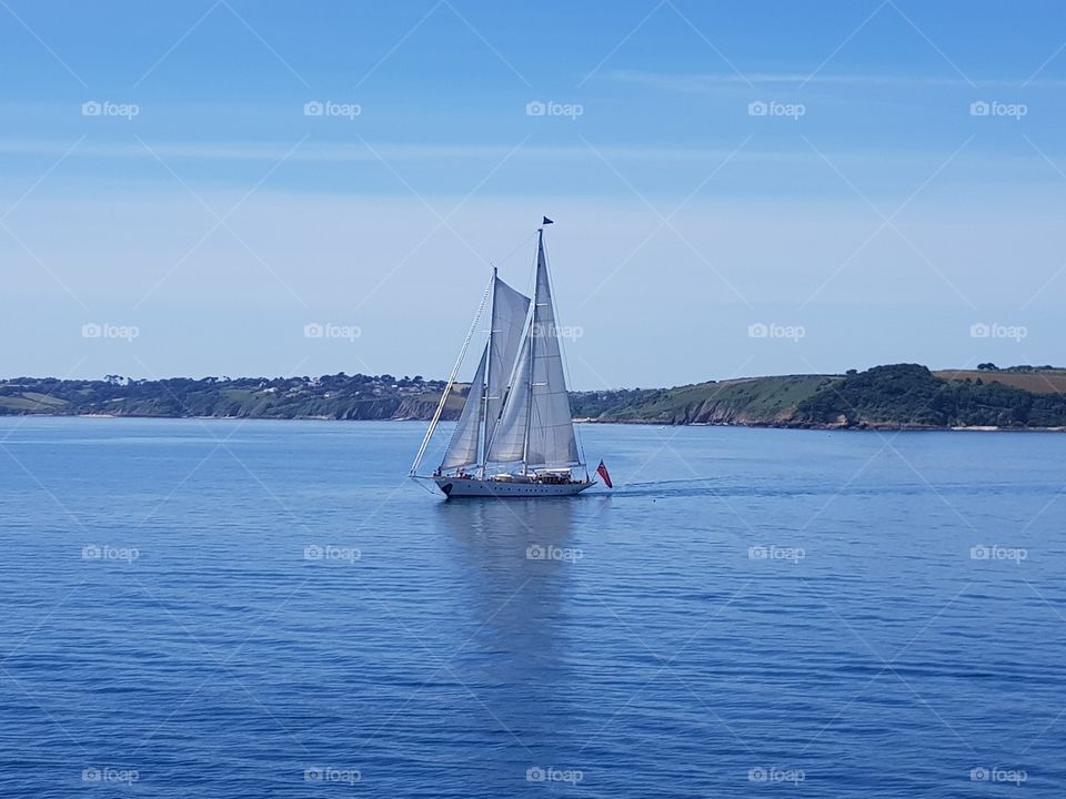 yacht sailing a calm sea on a beautiful sunny day