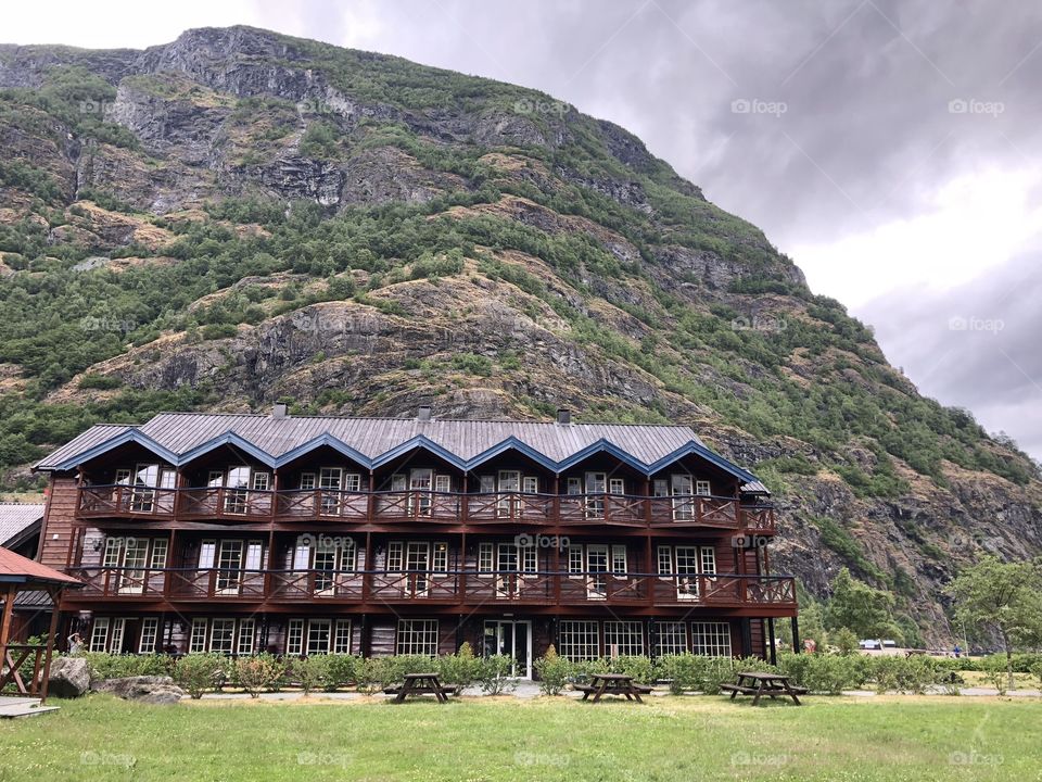 Norway. Apartments at the foot of a mountain in Flåm. Cloudy sky in the top corner adds some drama and texture